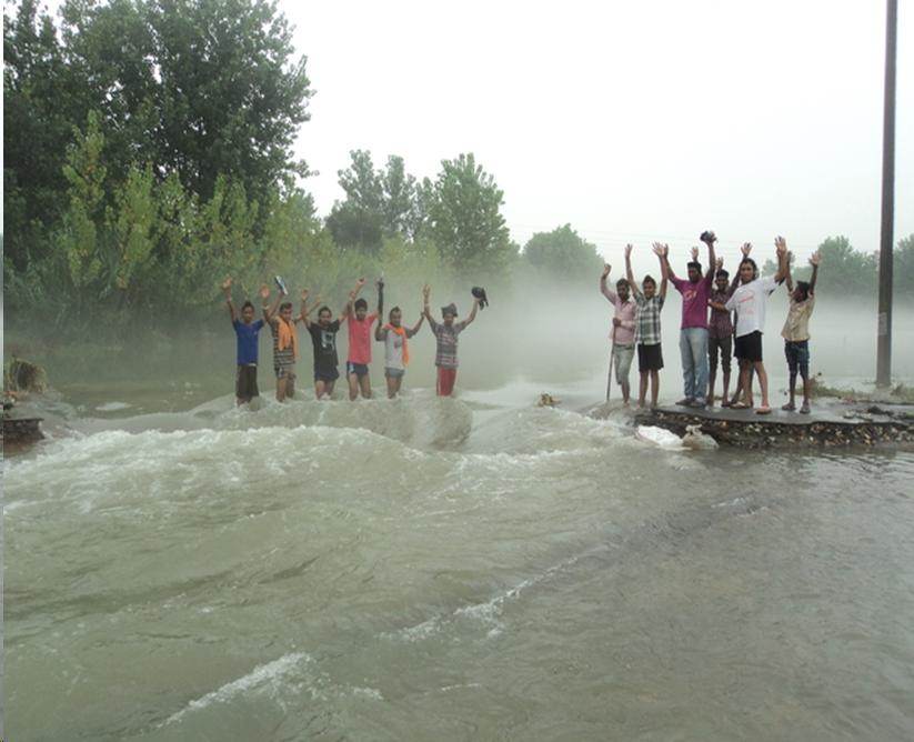 Image of flood with several people waiving
