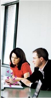 image of a man and woman sitting at a conference table talking.