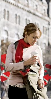 image of a college aged girl walking and reaching into her bag.