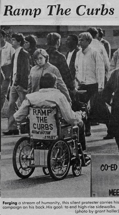 newspaper clipping with image of man using wheelchair with sign on the back that says "Ramp the curbs. Get me off the street."