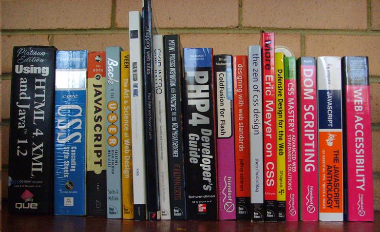 Computer books on a shelf with one titled "Web Accessibility"